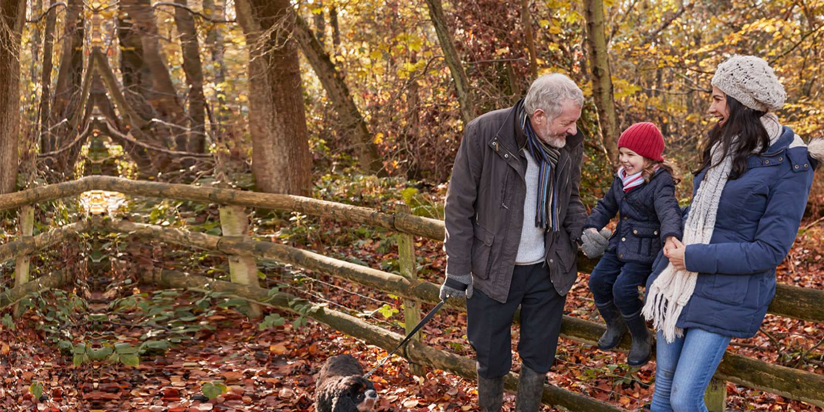 Mother child and granddad walking their dog on a leafy path. Family law solicitors, Family Law, Cohabitation