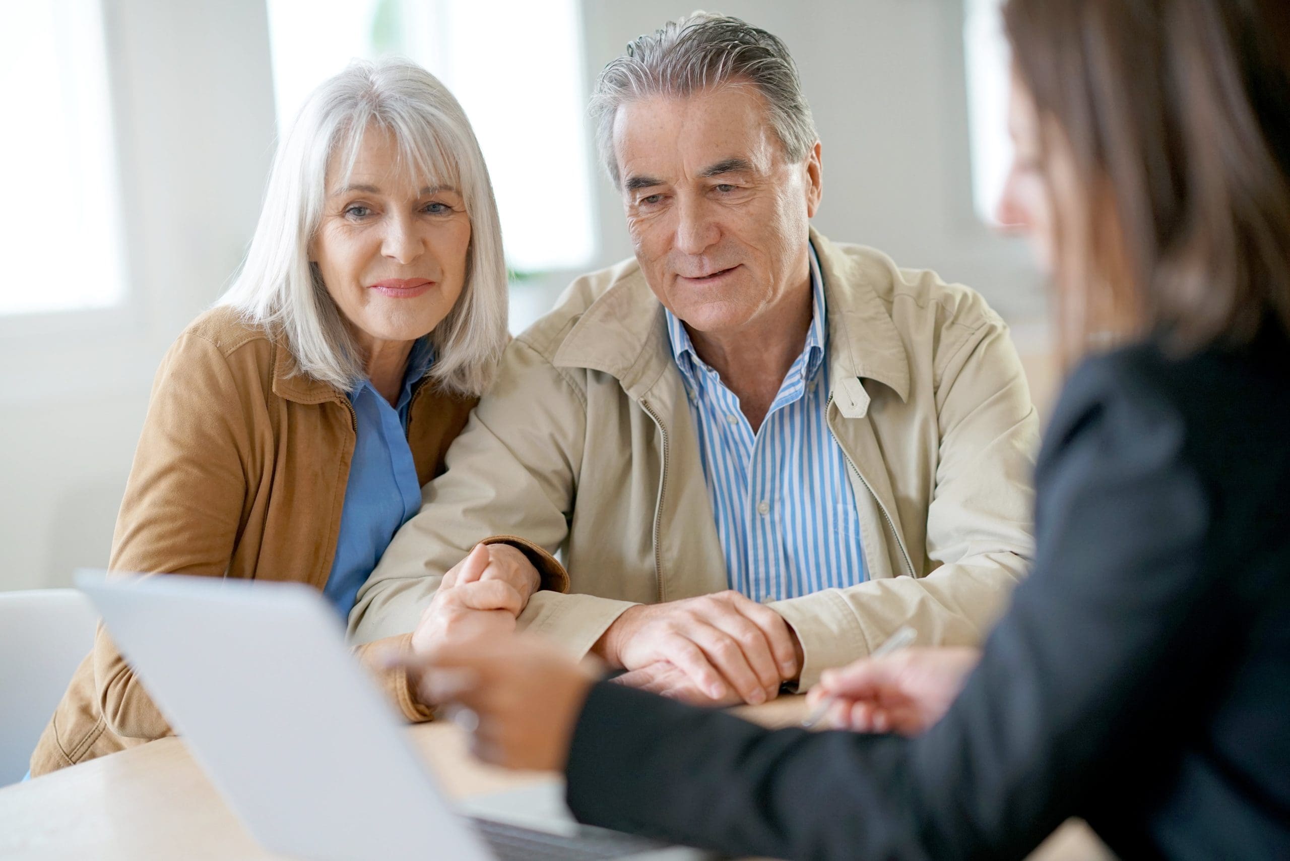 Older couple meeting with an independent financial adviser to discuss their long-term financial planning options.