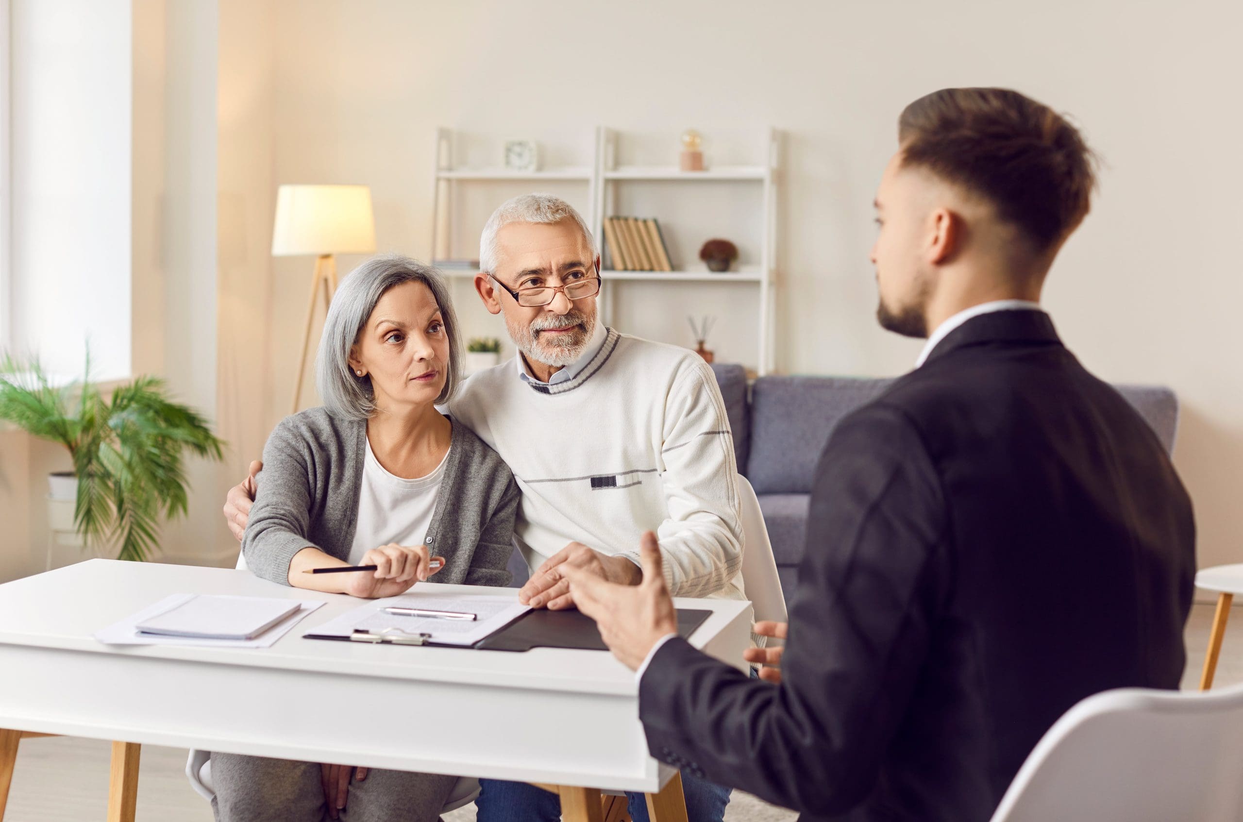 A couple meeting with a financial advisor or lawyer to discuss inheritance matters and financial planning.